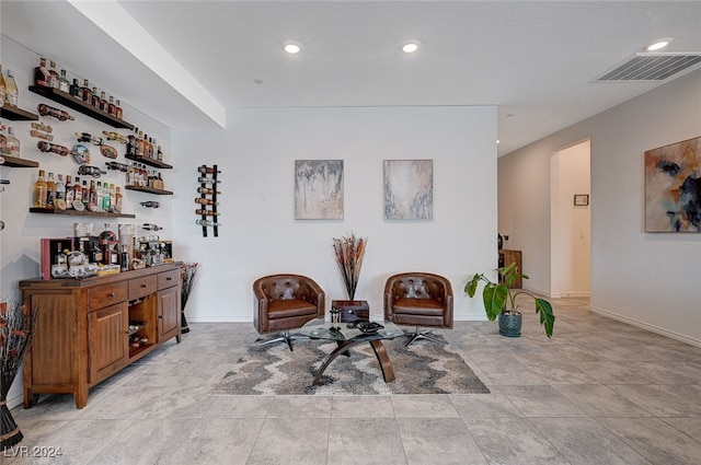 sitting room featuring indoor bar