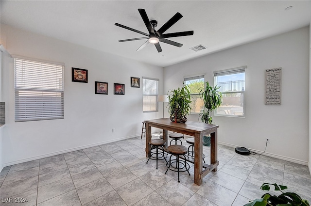 dining room with light tile patterned floors and ceiling fan