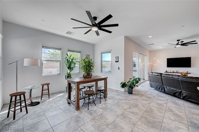 tiled dining area featuring plenty of natural light and ceiling fan