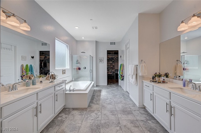 bathroom with shower with separate bathtub and vanity