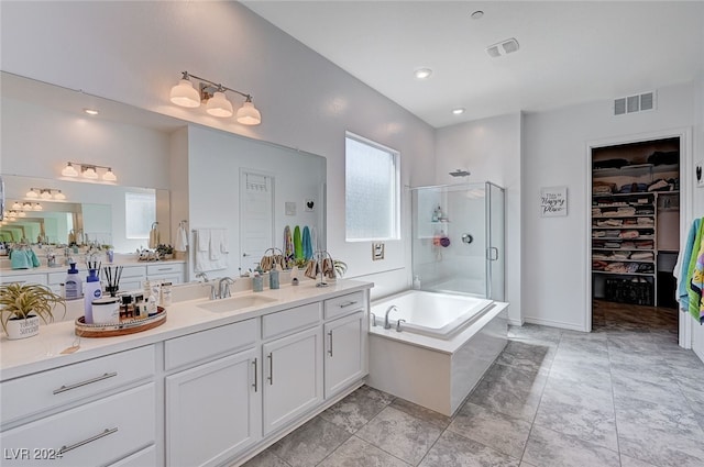 bathroom featuring vanity and shower with separate bathtub