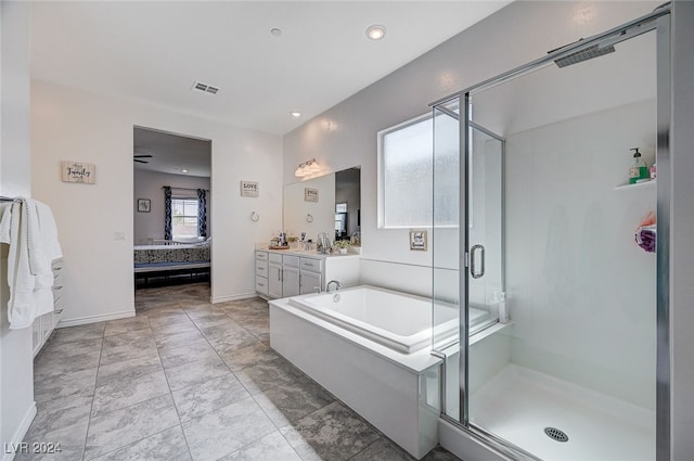 bathroom featuring ceiling fan, a shower with door, and vanity