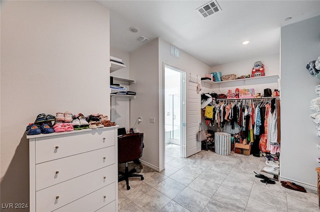 spacious closet featuring light tile patterned floors