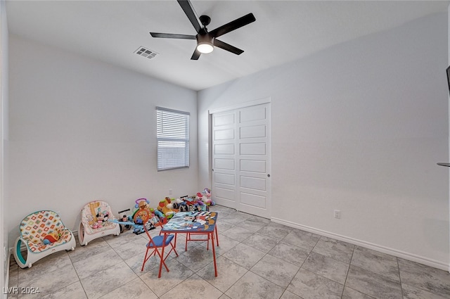 game room with ceiling fan and light tile patterned flooring