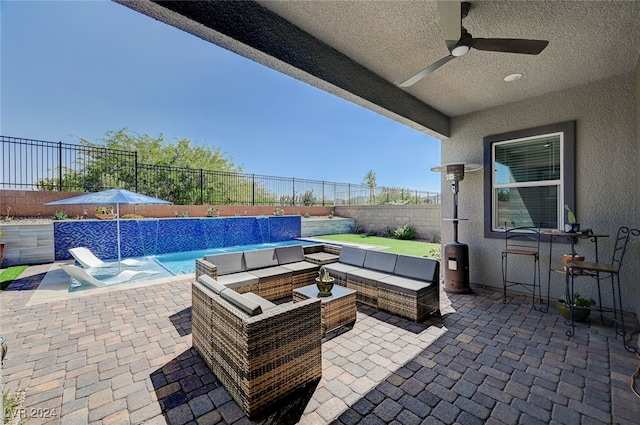 view of patio featuring outdoor lounge area, pool water feature, ceiling fan, and a fenced in pool