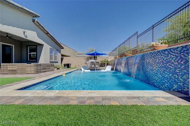 view of pool with a patio area and pool water feature