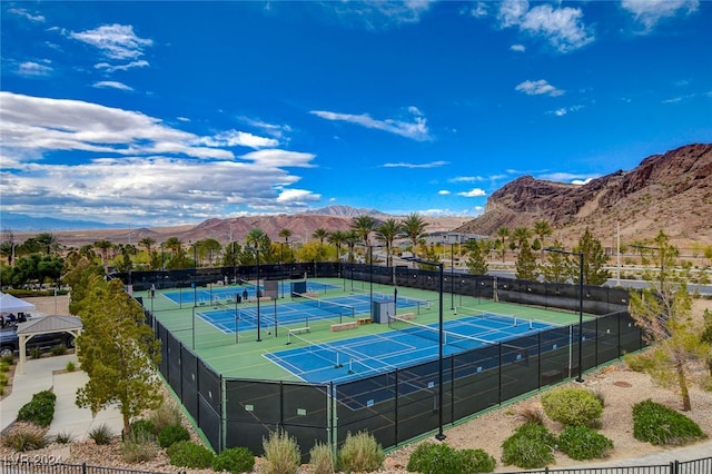 view of tennis court with a mountain view