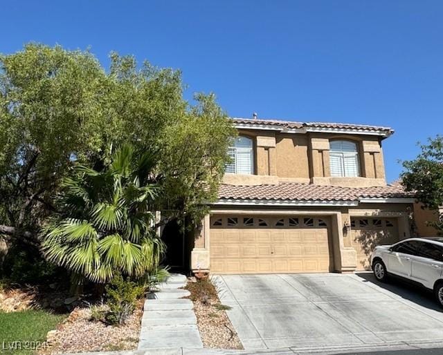 1024 Eaglewood Dr, Las Vegas, NV 89144 - mediterranean / spanish house with concrete driveway, a tiled roof, stucco siding, and a garage