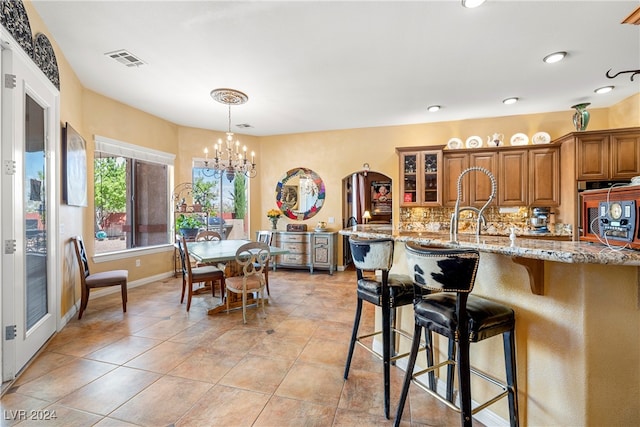 interior space with a chandelier and light tile patterned flooring