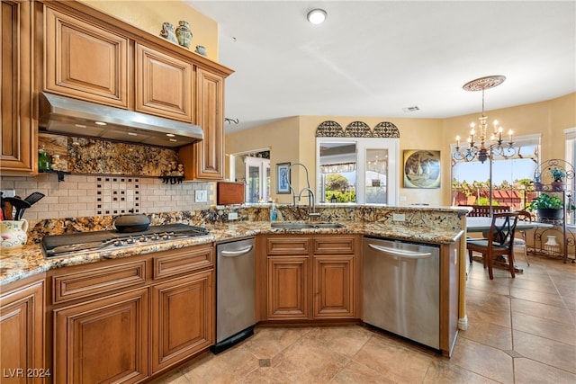 kitchen with sink, appliances with stainless steel finishes, backsplash, range hood, and light stone counters