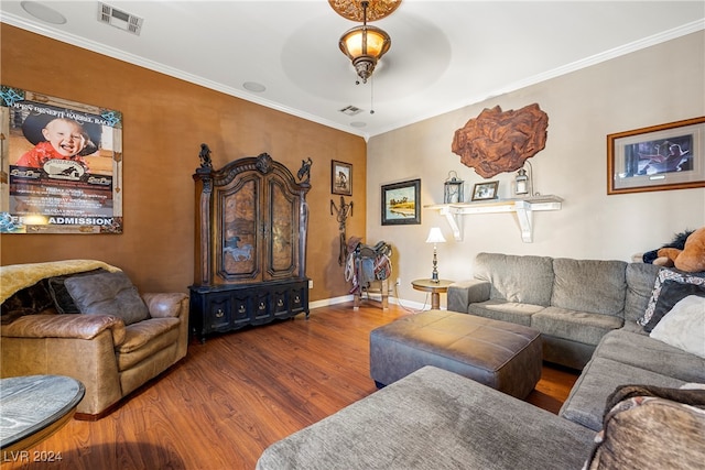 living room featuring crown molding, hardwood / wood-style floors, and ceiling fan