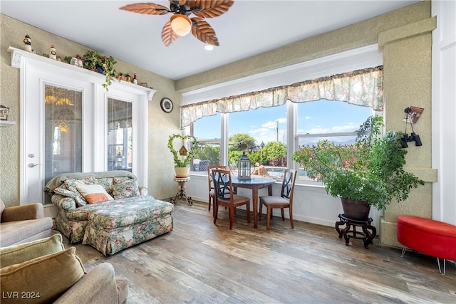 sunroom featuring ceiling fan