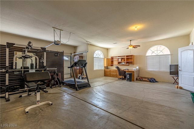 workout room featuring ceiling fan and a textured ceiling