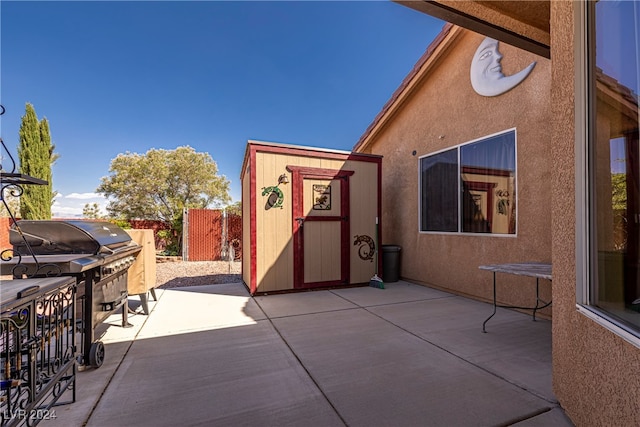 view of patio with a storage shed