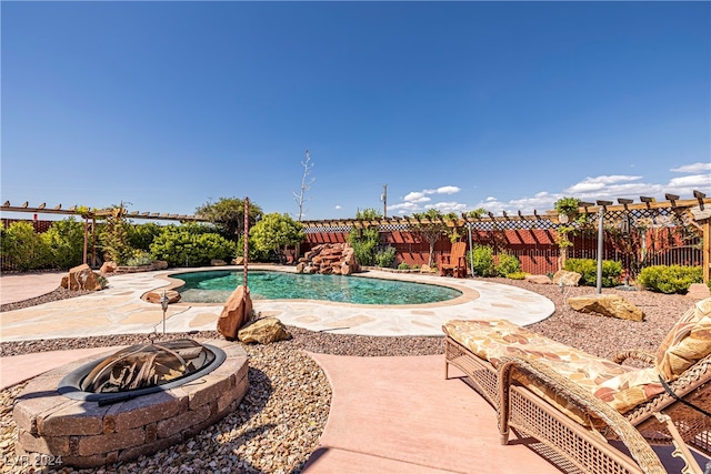 view of pool with a patio and an outdoor fire pit