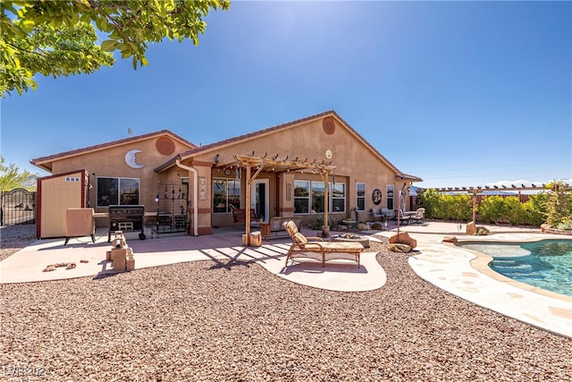 back of property featuring a fenced in pool, a pergola, and a patio area