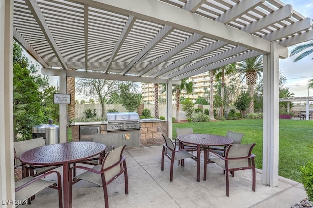 view of patio featuring exterior kitchen, grilling area, and a pergola