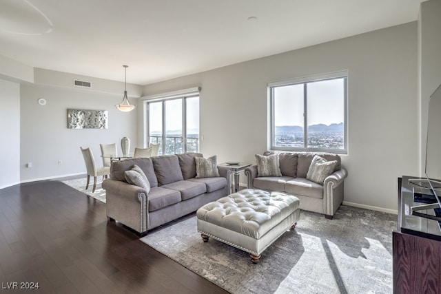 living room with dark wood-type flooring and a mountain view