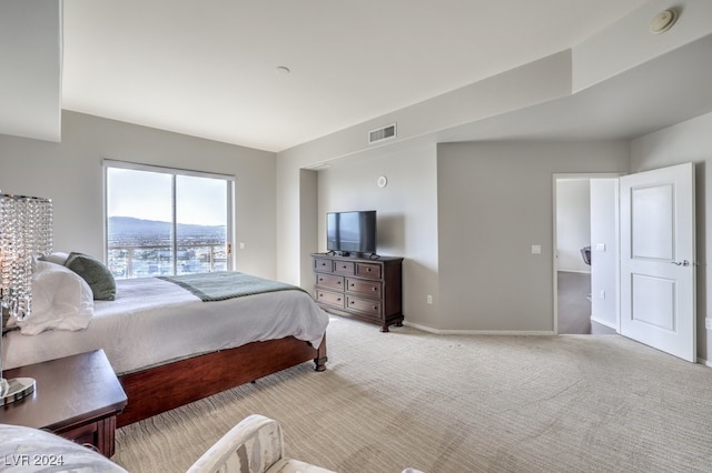 bedroom featuring baseboards, visible vents, and light colored carpet