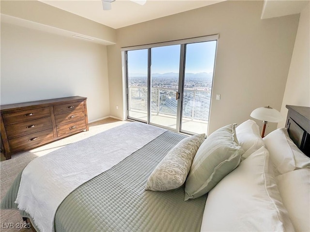 carpeted bedroom featuring a mountain view, access to exterior, and ceiling fan