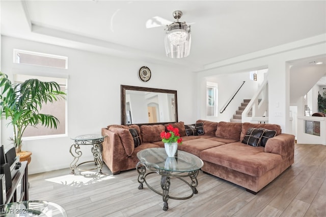 living room with a chandelier and light wood-type flooring