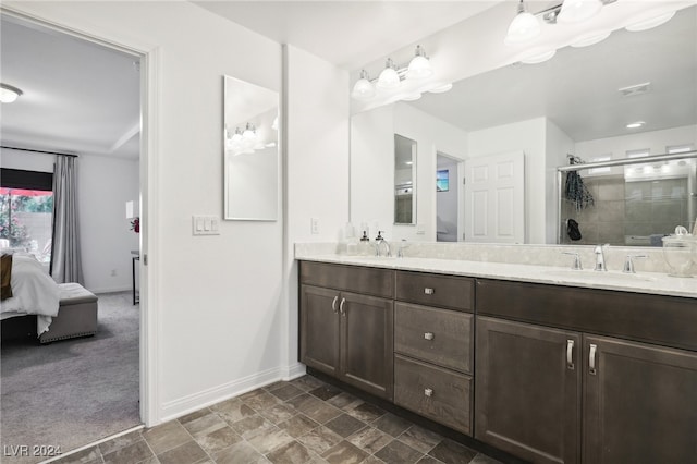 bathroom featuring vanity and a shower with shower door