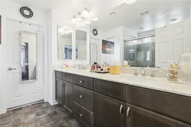 bathroom featuring vanity and an enclosed shower