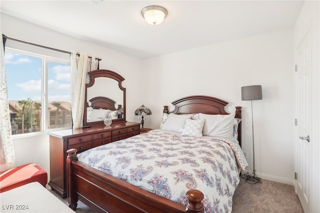 bedroom featuring light colored carpet and multiple windows