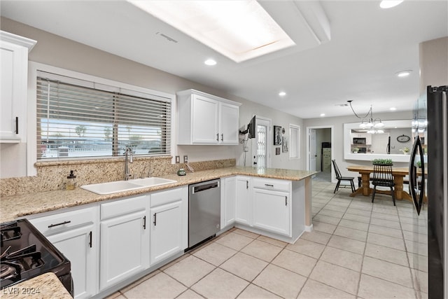 kitchen featuring kitchen peninsula, sink, light tile patterned floors, appliances with stainless steel finishes, and white cabinetry