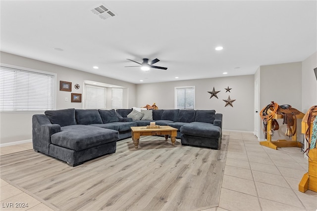 living room with ceiling fan and light tile patterned floors