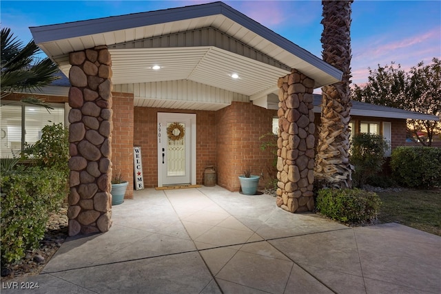 view of exterior entry at dusk