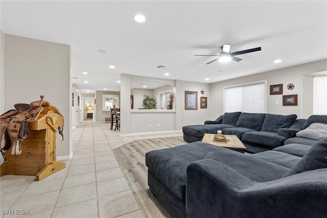 living room featuring light tile patterned floors and ceiling fan