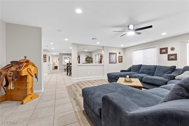 living room featuring ceiling fan and light tile patterned floors