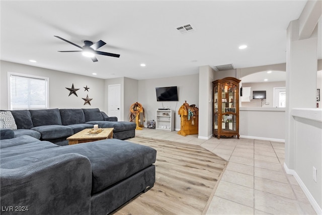 tiled living room featuring ceiling fan