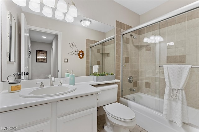 full bathroom with toilet, vanity, and combined bath / shower with glass door