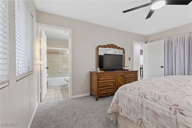 bedroom featuring ensuite bathroom, ceiling fan, and light carpet