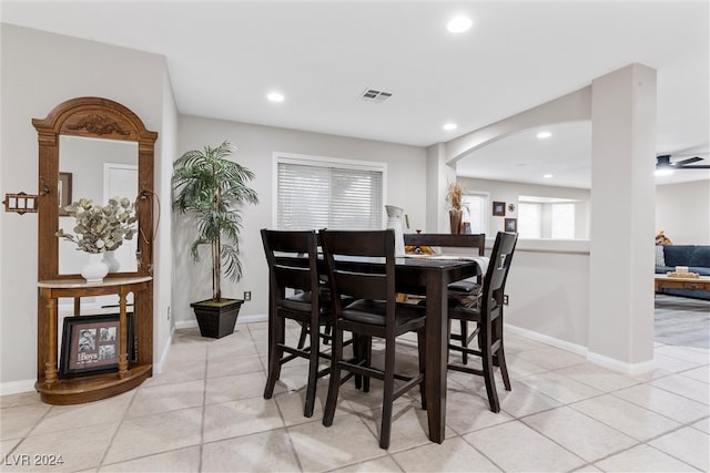 tiled dining space featuring ceiling fan