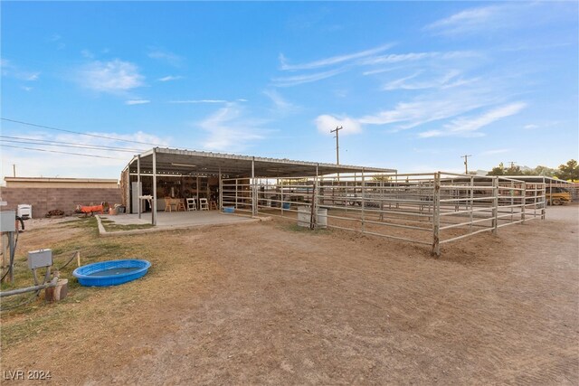 view of stable featuring a rural view