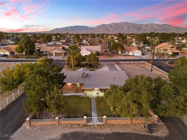 aerial view at dusk featuring a mountain view