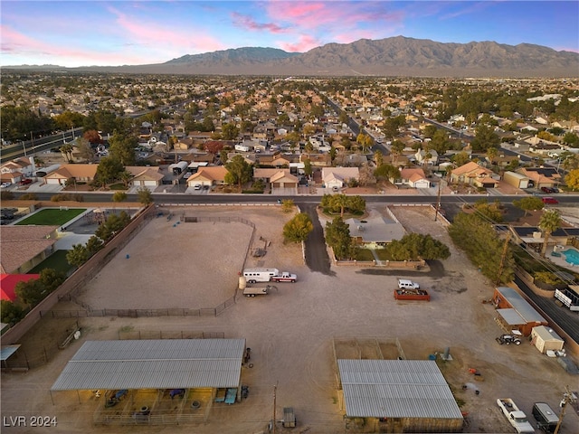 aerial view at dusk featuring a mountain view