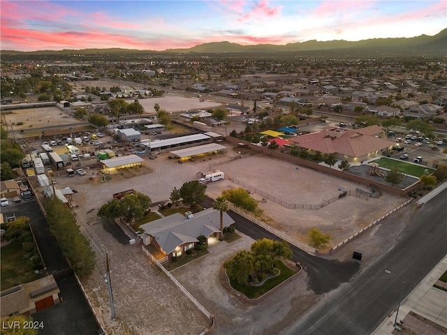 aerial view at dusk featuring a mountain view