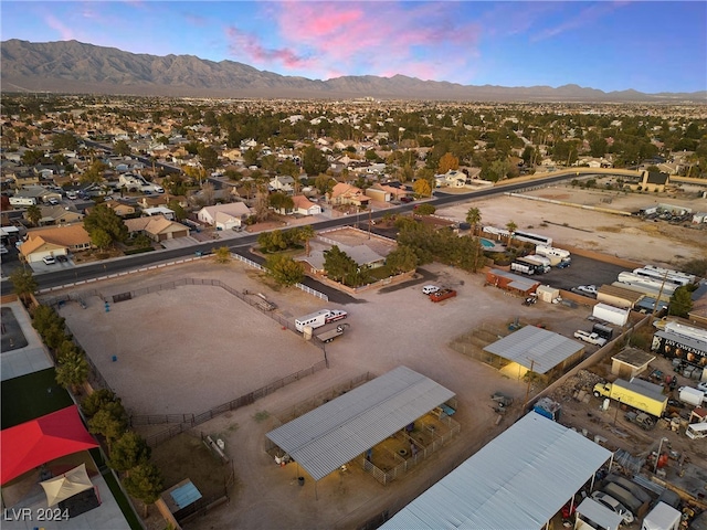 aerial view at dusk featuring a mountain view