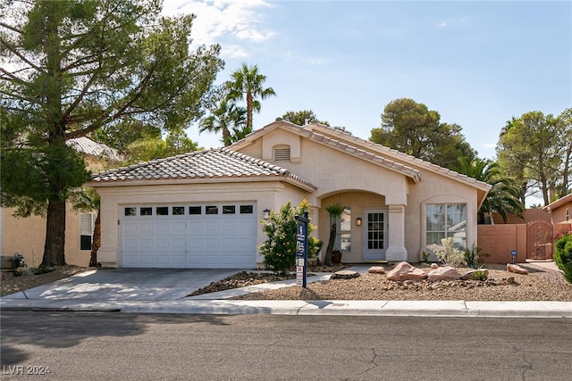 mediterranean / spanish home featuring a garage