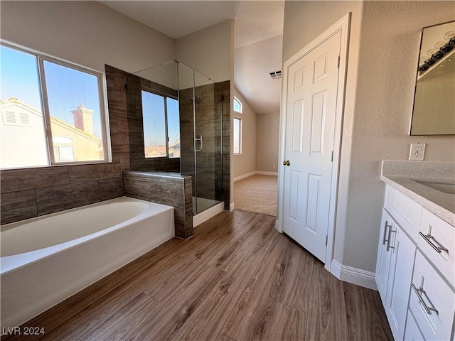 bathroom with shower with separate bathtub, vanity, hardwood / wood-style flooring, and a wealth of natural light