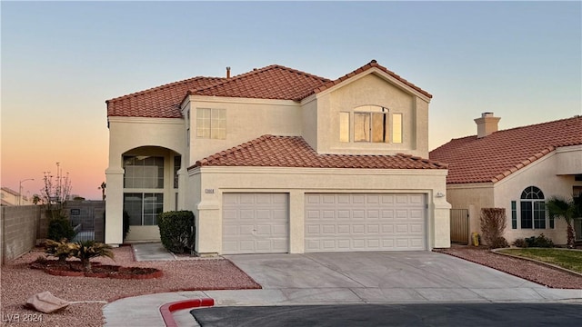 mediterranean / spanish-style house with a garage