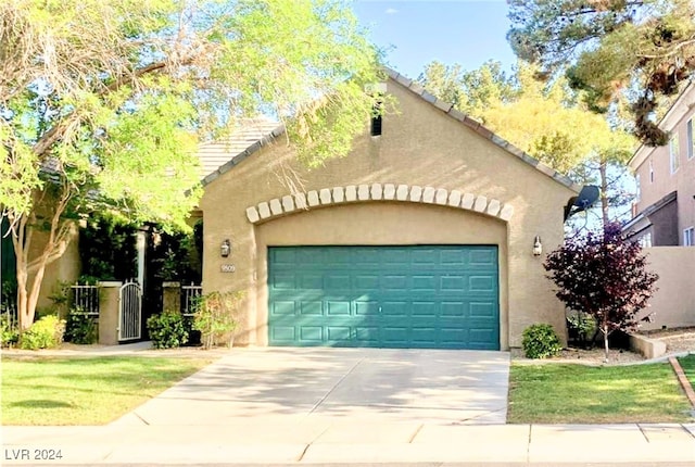 view of front facade with a garage and a front lawn