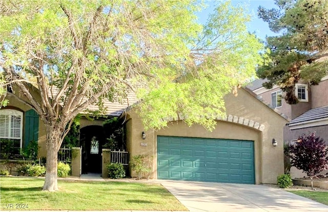 view of front of house with a front yard and a garage