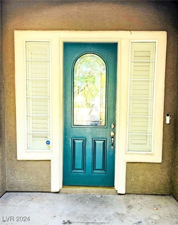 property entrance with stucco siding