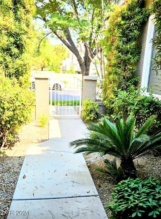 view of property's community with a gate and fence