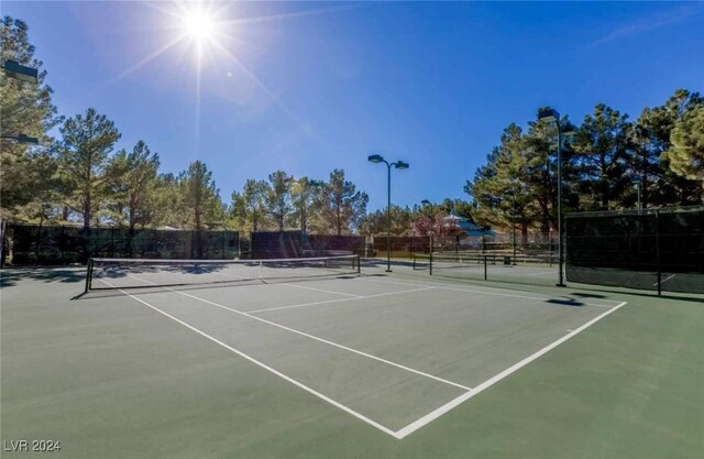 view of sport court featuring fence